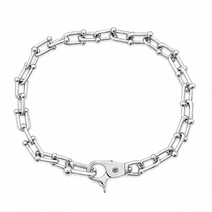 A silver-toned metal chain bracelet with alternating elongated links and small round beads, shown on a plain white background.