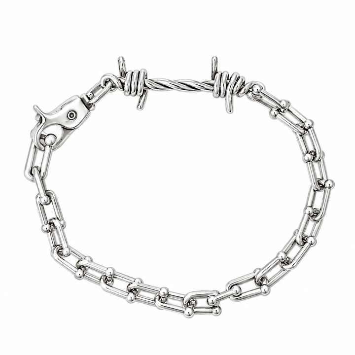 A silver-toned chain bracelet featuring alternating polished ball links and twisted barbed wire links, with a fish-shaped clasp, shown on a plain white background.