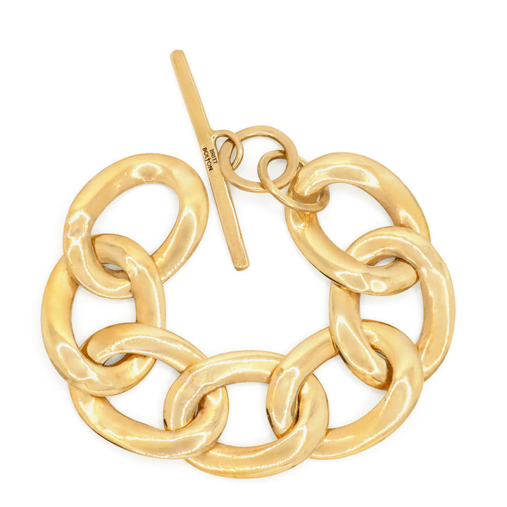 A gold-colored chain link bracelet with a glossy finish, featuring a series of interlinked gold chains.