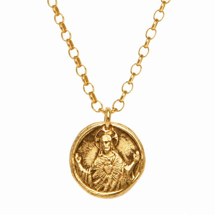 A gold chain necklace featuring a round, textured gold pendant with an embossed figure, shown against a plain white background.