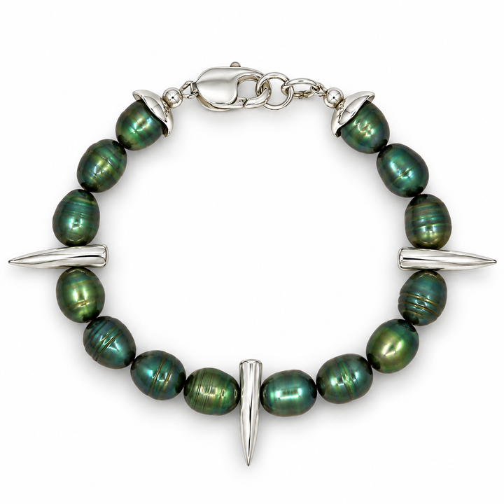 A silver-toned beaded bracelet featuring dark green iridescent baroque pearls and three silver spike charms, displayed on a clean white background.