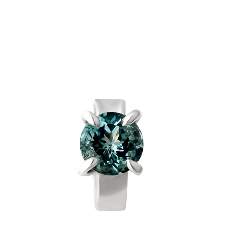 Silver ear cuff with a large blue gemstone on a white background