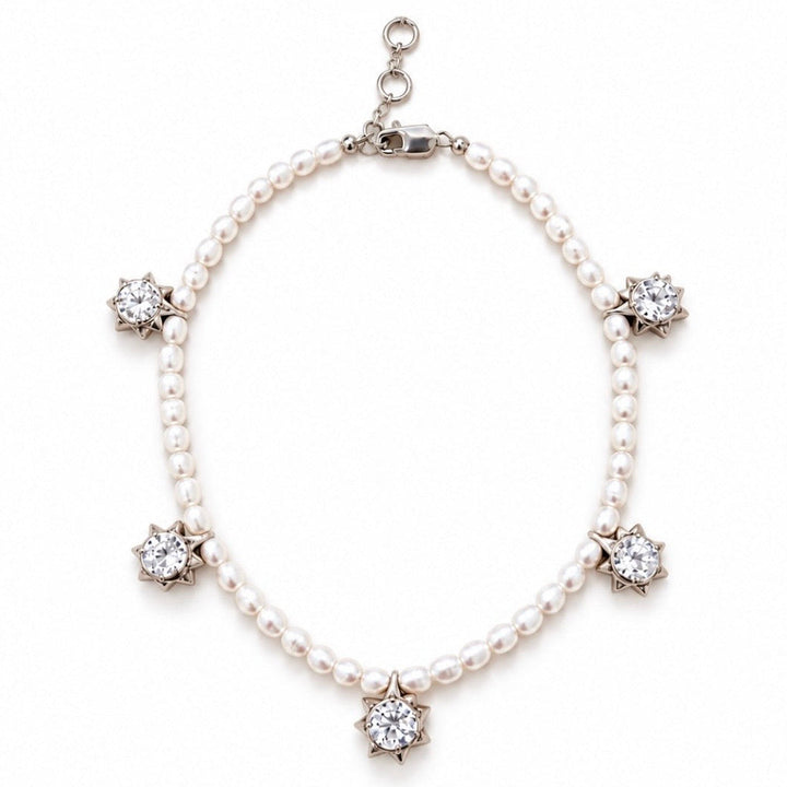 A pearl necklace with five star-shaped diamond clusters set in silver-toned metal, displayed on a clean white background.