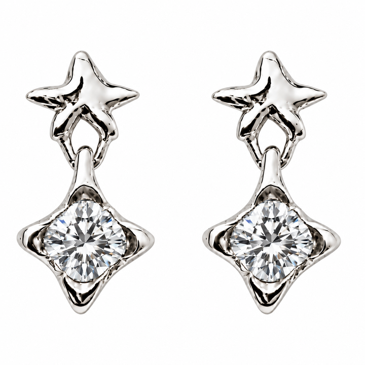 A pair of silver-toned drop earrings, each featuring a small star-shaped stud above a larger four-pointed star setting holding a round brilliant-cut clear gemstone, shown on a plain white background.