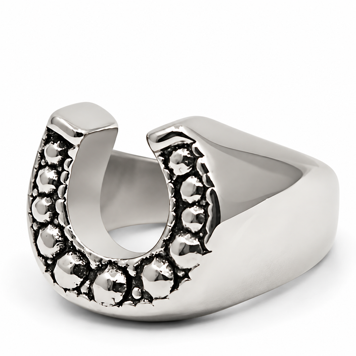 A polished silver horseshoe ring with textured, oxidized detailing along the outer curve, shown on a clean white background.