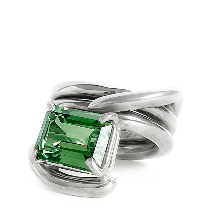 Silver ring with a green gemstone on a white background