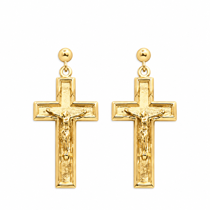 A pair of gold crucifix earrings with detailed corpus figures and round stud posts, shown on a plain white background.