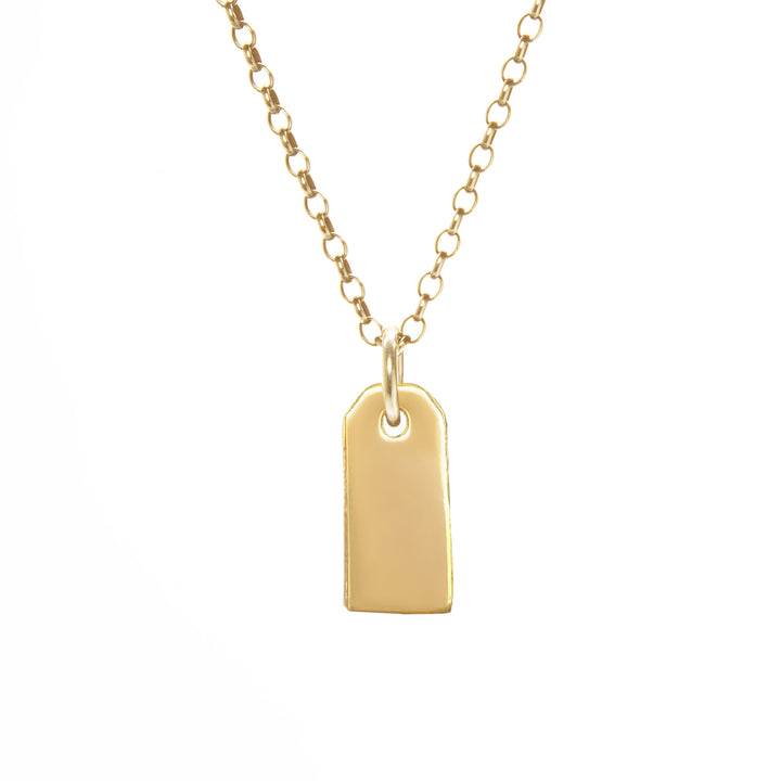 Gold necklace with a tag pendant on a white background