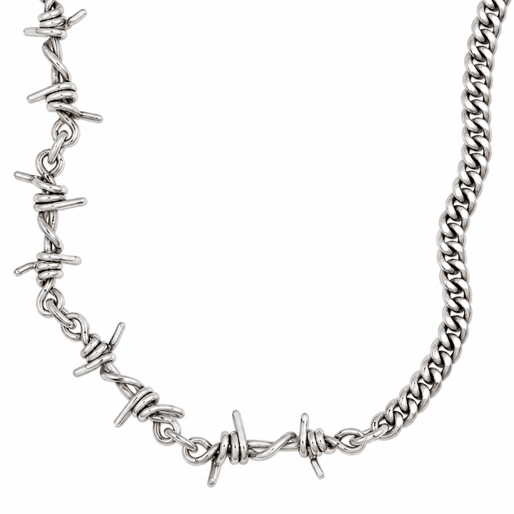 A silver-toned metal chain necklace featuring multiple barbed wire motifs along the front, shown against a plain white background.