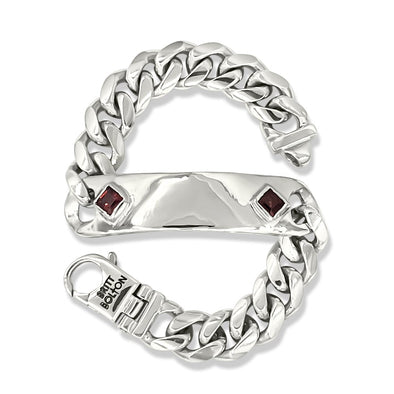 Silver chain-style bracelet with embedded gemstones on a white background