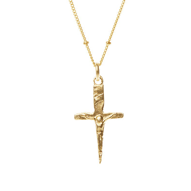 Gold cross pendant necklace on a white background