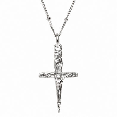 A silver crucifix pendant necklace featuring a textured dagger hilt and a detailed figure of Jesus Christ, suspended from a delicate silver chain against a plain white background.