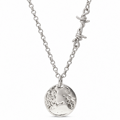 A silver necklace featuring a textured circular pendant with an engraved map design, suspended from a chain with a barbed wire accent clasp, shown against a plain white background.