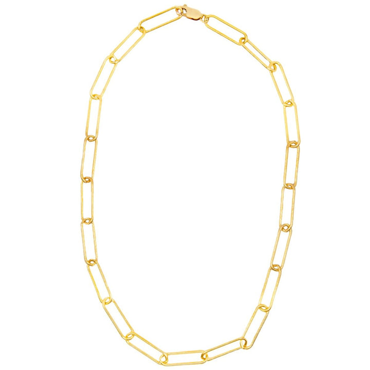 A gold-filled paperclip chain necklace laid out on a plain background.