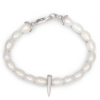 Pearl bracelet with a silver spike charm on a white background