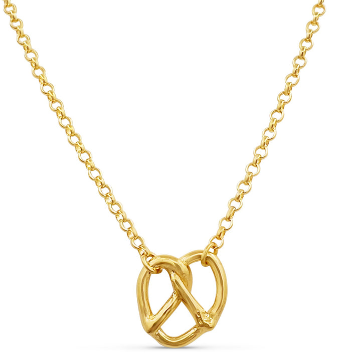 Gold necklace with a Pretzel shaped pendant pendant on a white background