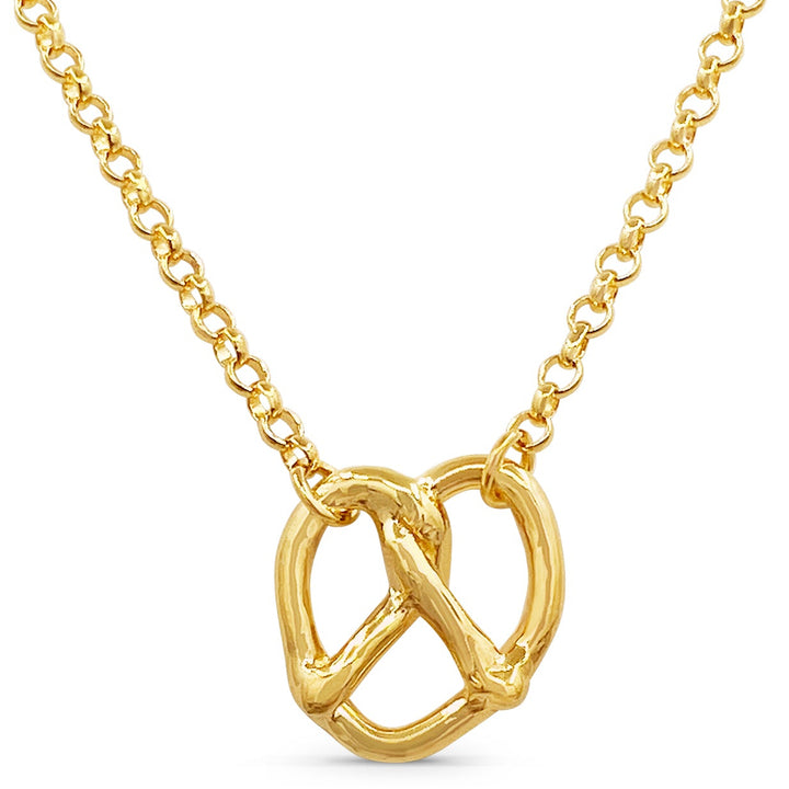 Gold pretzel-shaped pendant on a chain against a white background