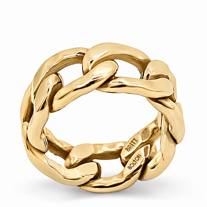 A polished yellow gold ring with a thick, interlocking curb-link design, shown on a clean white background. The brand name 'BRITT ROLO' is engraved on the inside of the band.