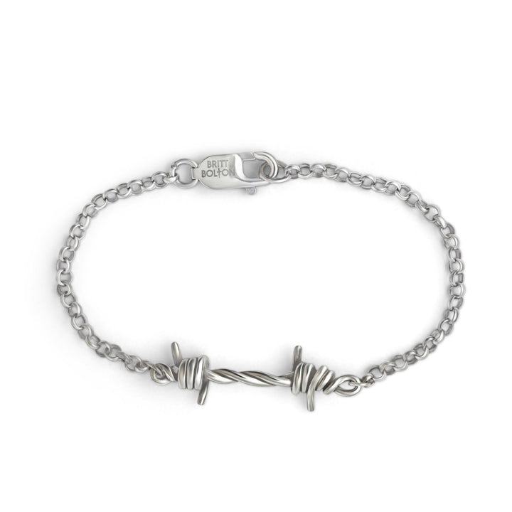 Silver bracelet with barbed wire design on a white background