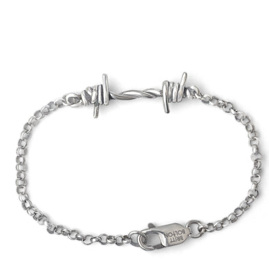 Silver bracelet with barbed wire design on a white background