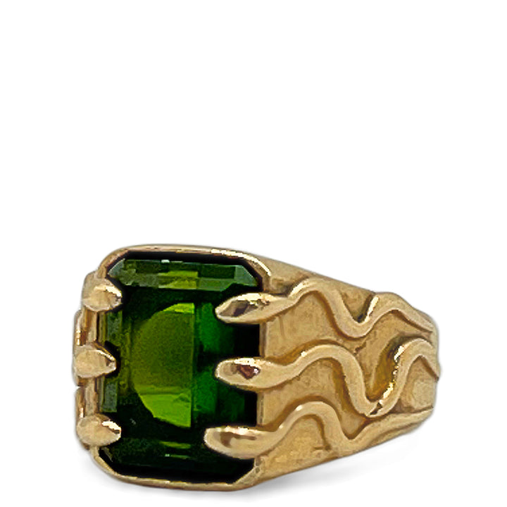 Gold ring with a green gemstone on a white background