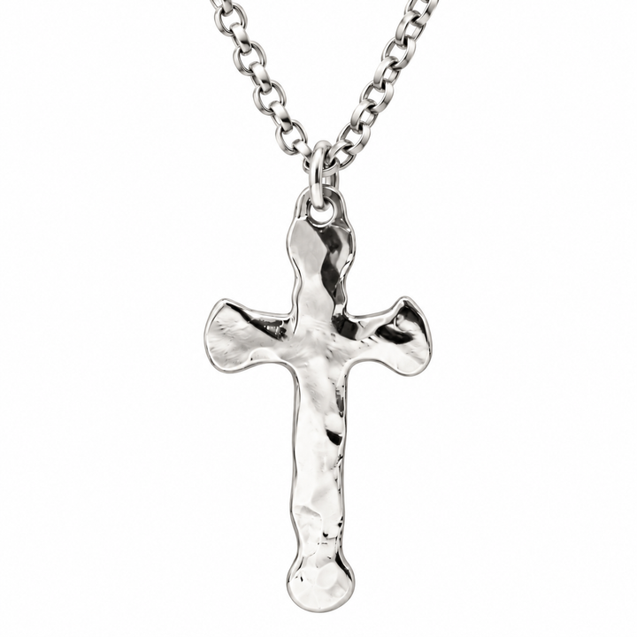 A polished silver cross pendant necklace with a textured, hammered finish, suspended from a matching silver link chain against a plain white background.