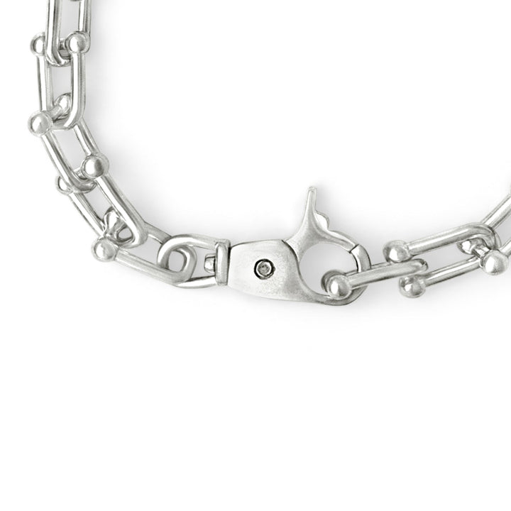 Silver chain bracelet on a white background