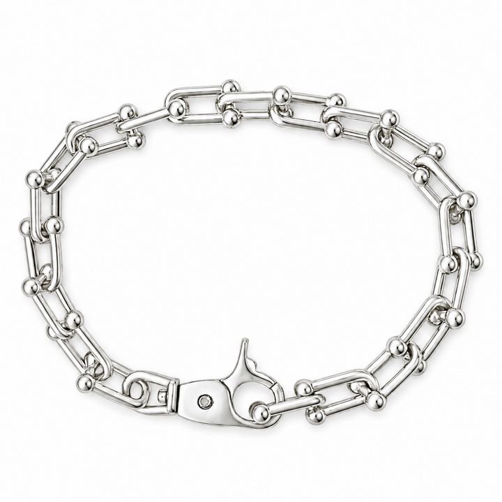 A silver-toned metal chain bracelet with a lobster clasp, displayed on a clean white background.
