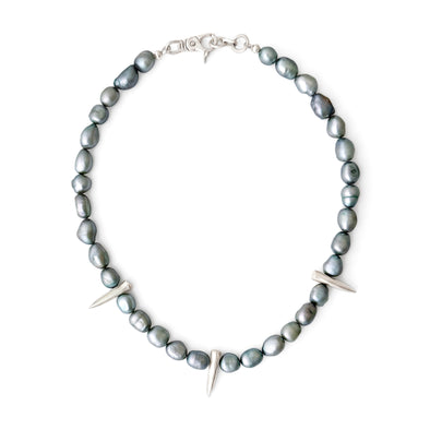 Necklace with gray beads and silver accents on a white background