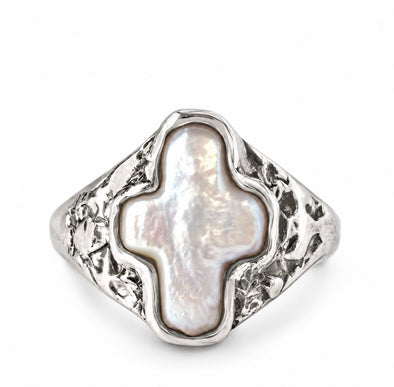 A silver signet ring featuring a large, irregularly shaped white mother-of-pearl cross-shaped centerpiece, set against a clean white background.