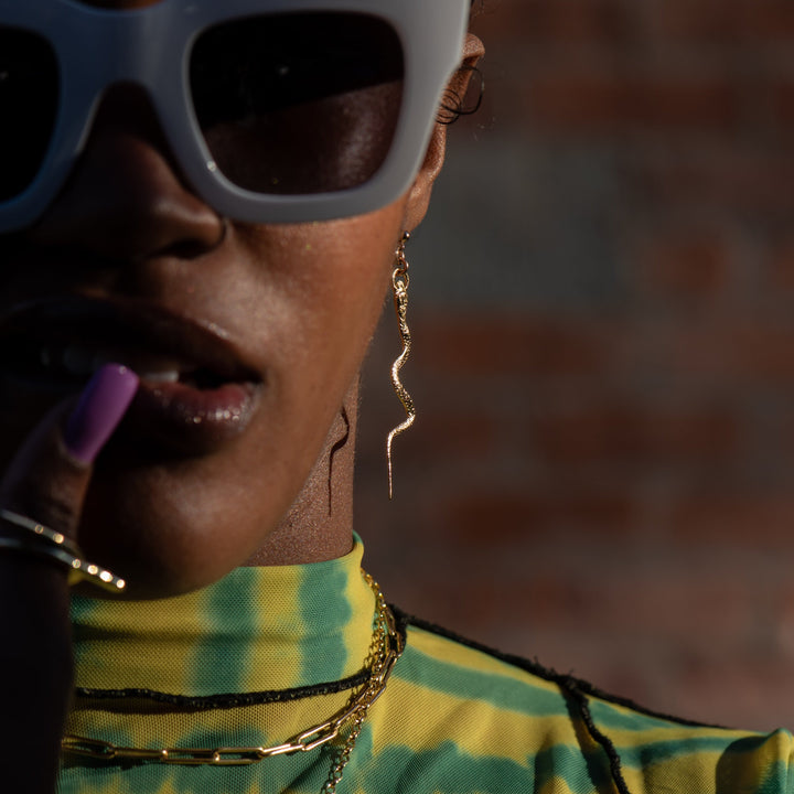 close up shot of female model wearing our snake stud earrings