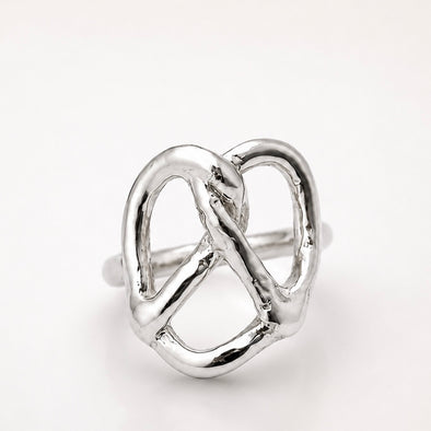 Silver pretzel ring on a white background