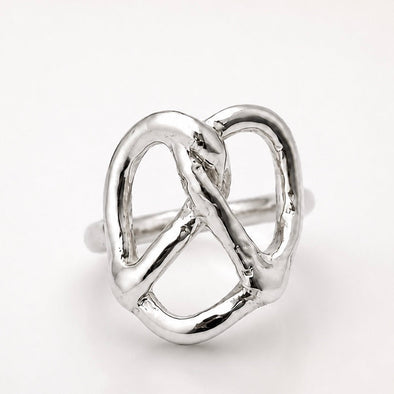 Silver pretzel ring on a white background