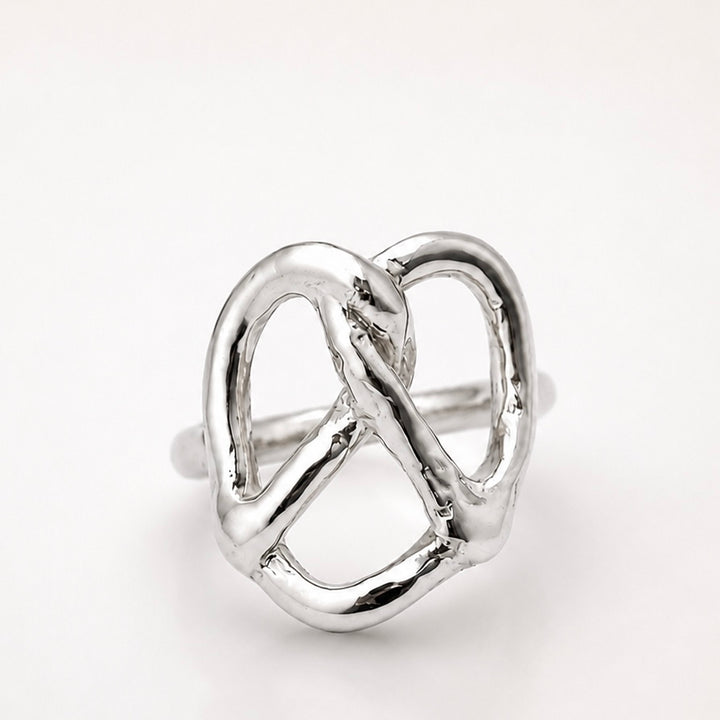Silver pretzel ring on a white background