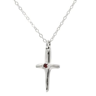 sterling silver cross pendant with red garnet in the center, hanging from silver rolo chain