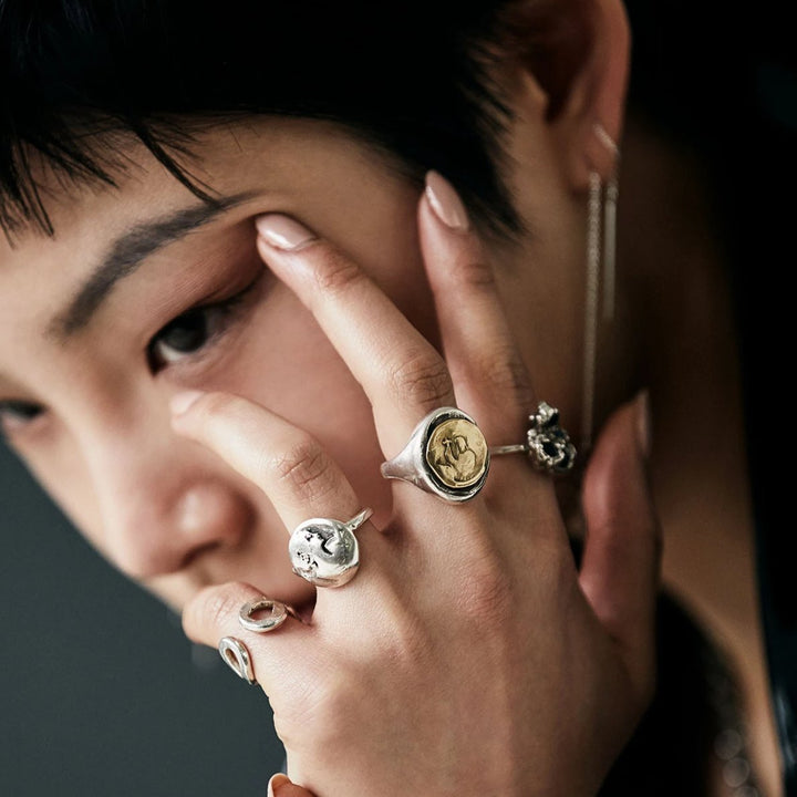 model wearing our Sterling Silver Holy Biker Ring. Oval shaped signet ring with 14k Yellow Gold holy coin detail