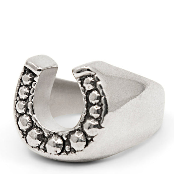 Silver Horse shoe ring with studs on a white background