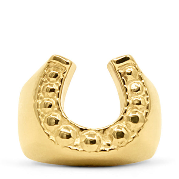 Gold horseshoe ring on a white background