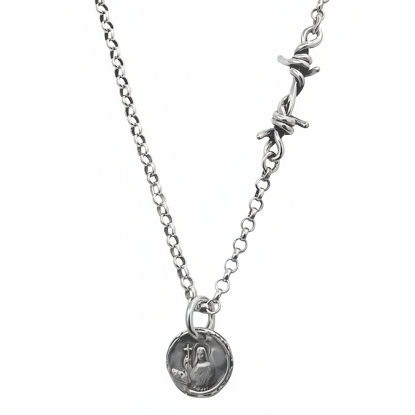 Silver necklace with a round pendant on a white background