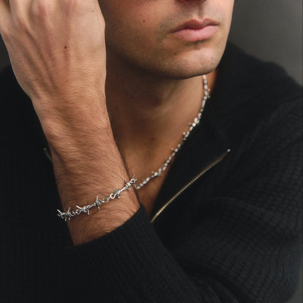 Man wearing a silver bracelet with a subtle design