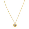Gold necklace with a round pendant on a white background