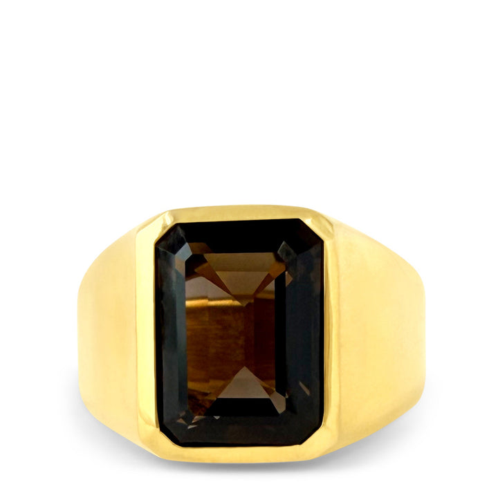 Gold ring with a rectangular smoky gemstone on a white background