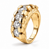 A yellow gold ring featuring a row of clear round-cut gemstones set in a textured, claw-like setting. The ring is photographed on a clean white background with a soft shadow.