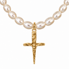 A close-up of a necklace featuring irregular white freshwater pearls and a textured gold crucifix pendant on a plain white background.