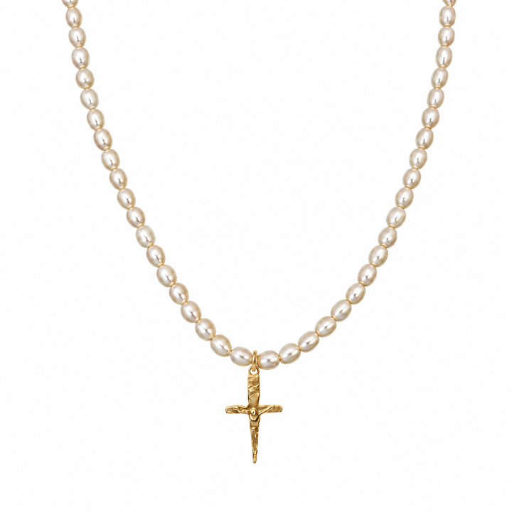 A pearl necklace with a textured gold crucifix pendant, displayed against a solid white background.