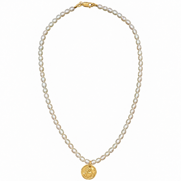 A classic pearl necklace with a gold clasp and a gold circular medallion pendant, displayed on a clean white background.