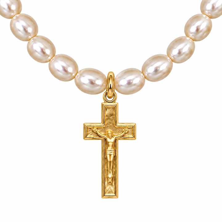 A strand of lustrous white freshwater pearls arranged in an oval, with a gold crucifix pendant hanging from the center against a plain white background.