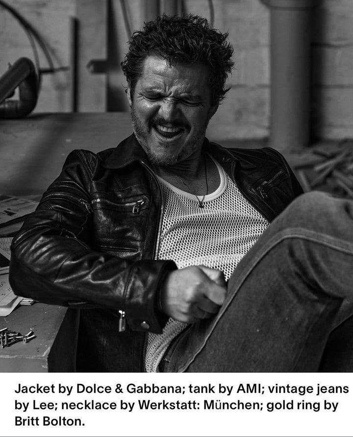 Man wearing Dolce & Gabbana jacket and AMI tank top in a black and white setting.