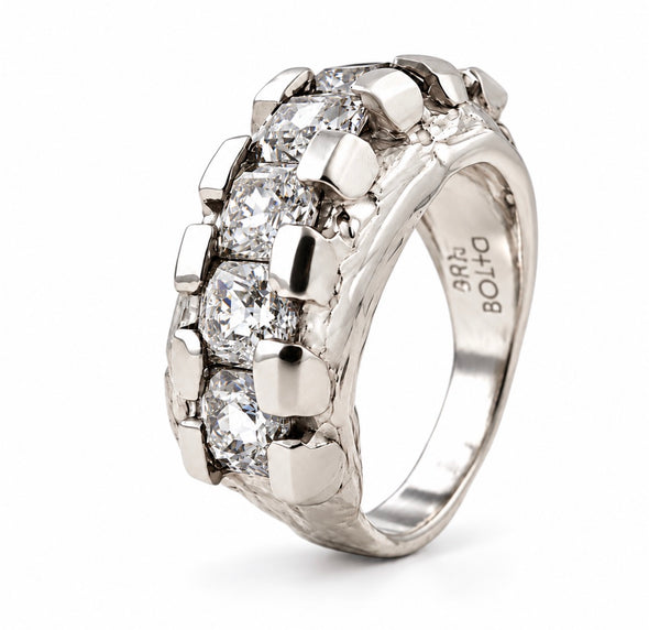 A silver ring with a double row of round-cut clear gemstones in a polished bezel setting, shown on a white background. The inside of the band is engraved with 'ARS BOLLO'.