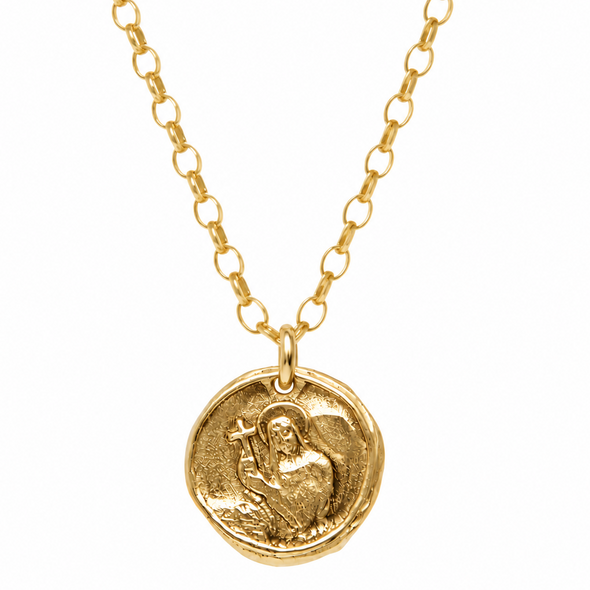 A gold coin pendant necklace featuring an embossed figure holding a cross, suspended from a delicate gold link chain against a solid white background.
